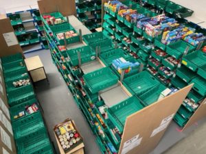 Warehouse shelving with crates of foodbank donations